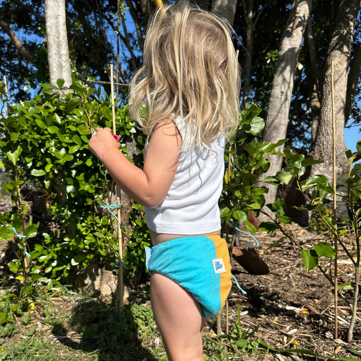 Gogo Shorties Merino-blend Toilet Training Pants - Size Small. Child in garden.