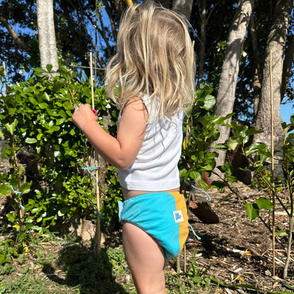 Gogo Shorties Merino-blend Toilet Training Pants - Size Small. Child in garden.